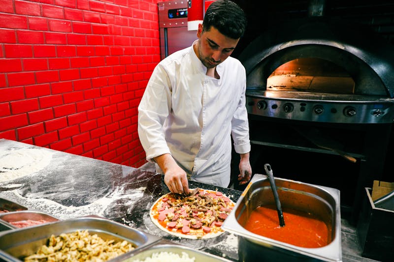 Jet's pizza kitchen — fresh pizza being crafted